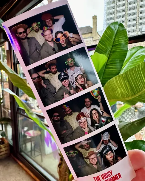 Strip of photobooth portraits of Vidsy teammates posing together among houseplants