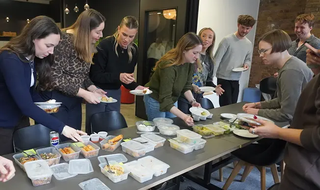 Vidsy team plating up food together at a studio cooking session